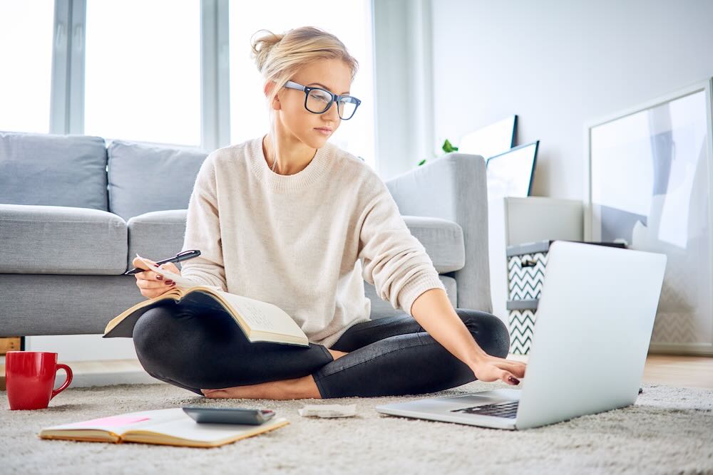 Woman using laptop paying bills online and managing home budget 